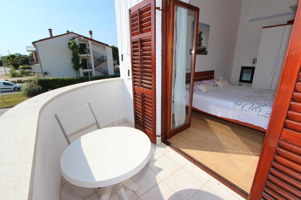 Postel nebo postele na pokoji v ubytování Rooms and Apartment Luana