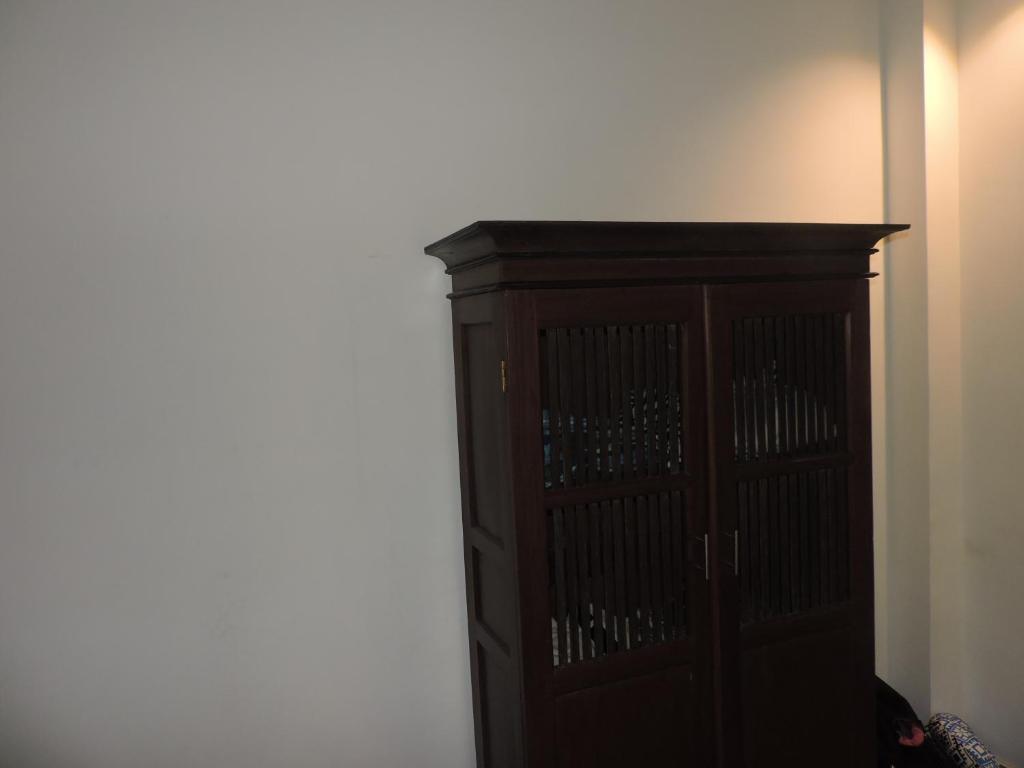 a wooden cabinet in the corner of a room at Silva Rest in Unawatuna