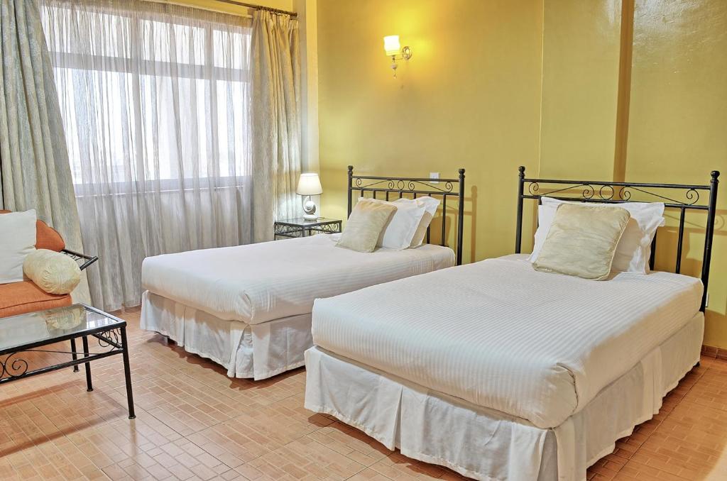 Postel nebo postele na pokoji v ubytování Space International Hotel