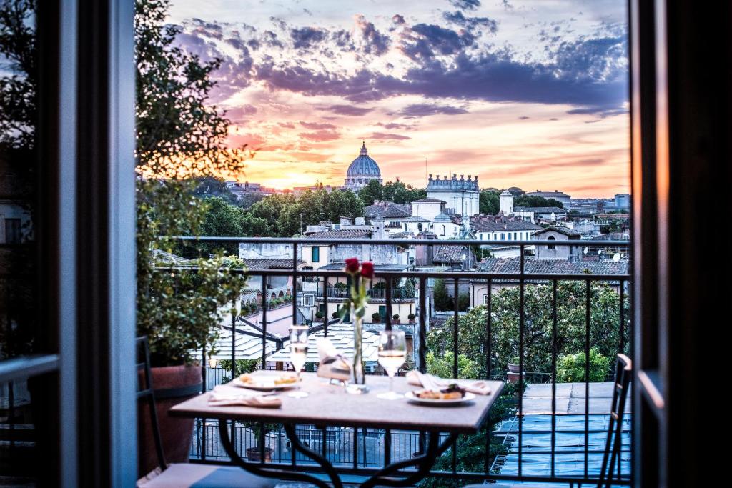a table on a balcony with a view of a city at Hotel Ponte Sisto in Rome