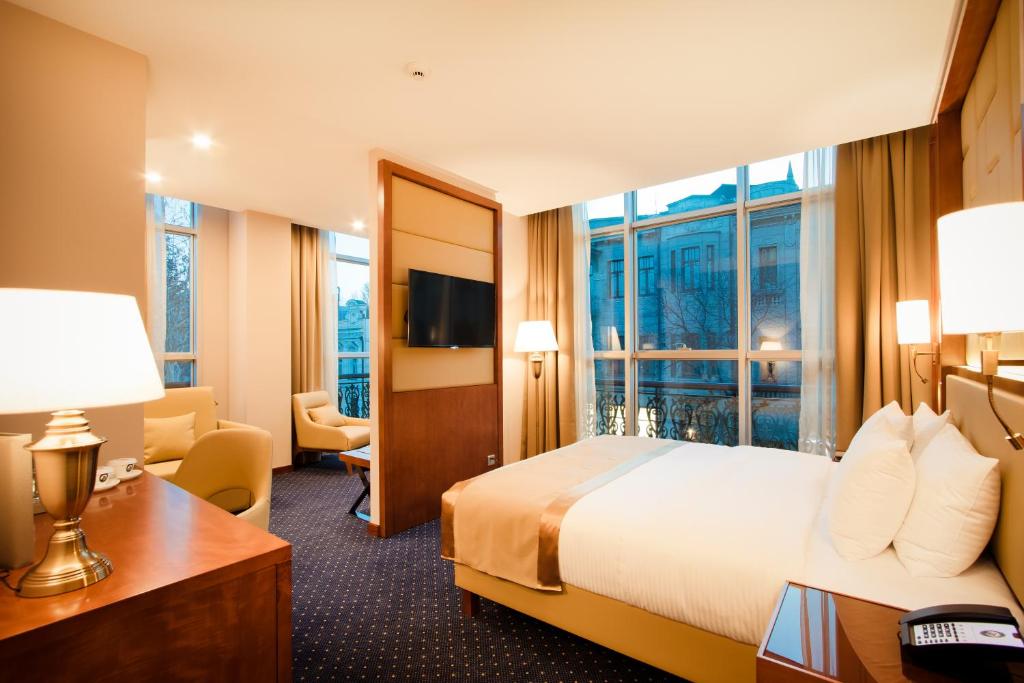 Postel nebo postele na pokoji v ubytování New Tiflis Hotel
