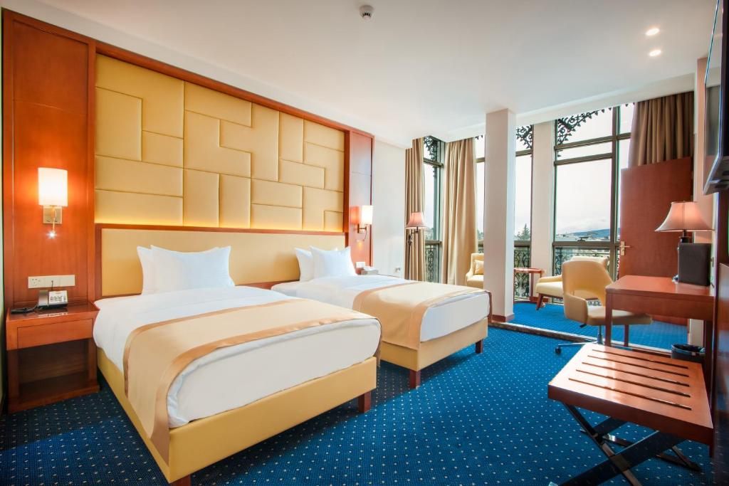 Postel nebo postele na pokoji v ubytování New Tiflis Hotel