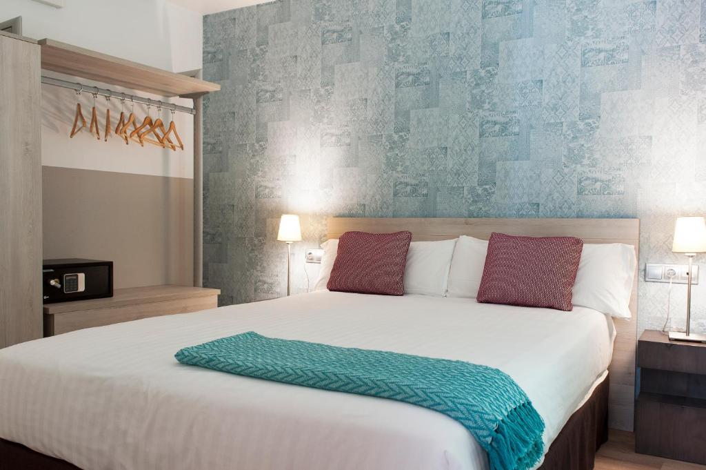 Posteľ alebo postele v izbe v ubytovaní MH Apartments S. Familia