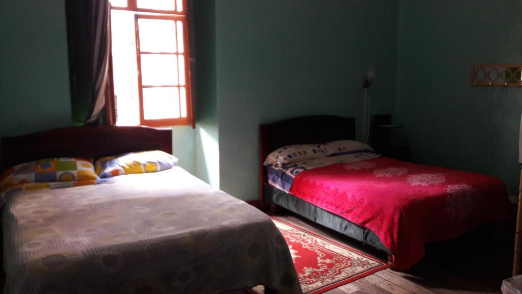 Postel nebo postele na pokoji v ubytování Hostal La Chorrera