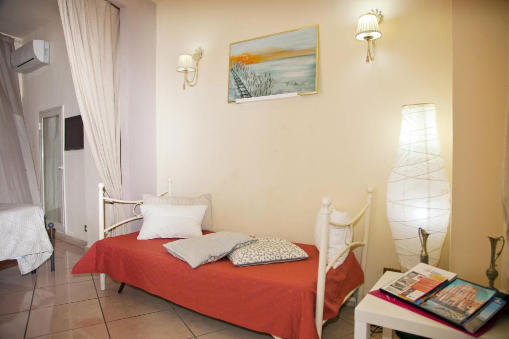 a bedroom with a bed with a red blanket at B&B Garibaldi in Catania