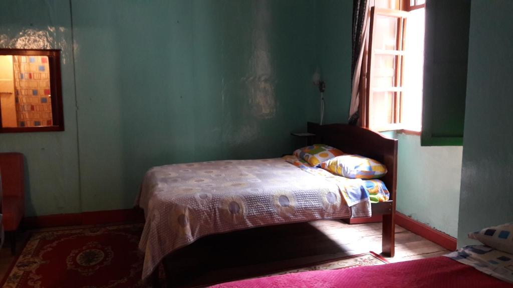 Postel nebo postele na pokoji v ubytování Hostal La Chorrera
