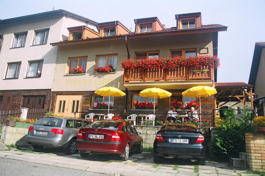 three cars parked in front of a building at Penzion Gerta in Český Krumlov