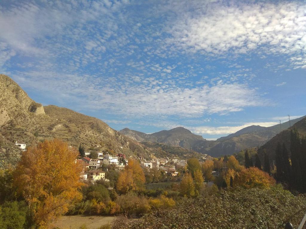 a view of a town in a mountain valley at Apartamento Granada Monachil I in Monachil