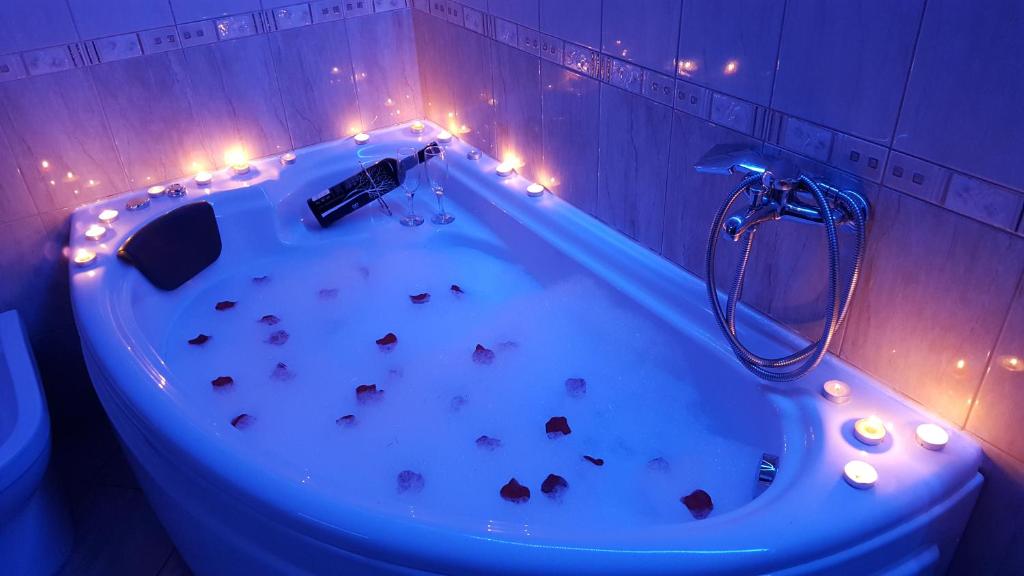 a bathroom with a bath tub with rocks in it at Petreski Apartments 1 in Ohrid