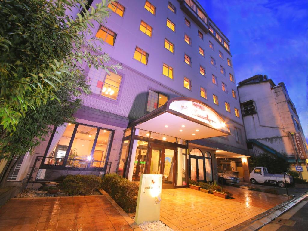 a building with a sign in front of it at Hotel Claire Higasa in Himeji