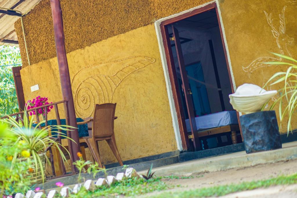 a house with a painting on the side of it at Walampuri Cabana & Restaurant in Tangalle