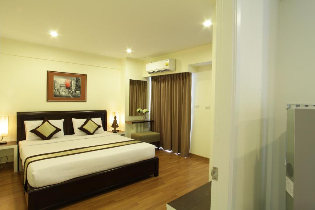 En eller flere senger på et rom på Nanatai Suites