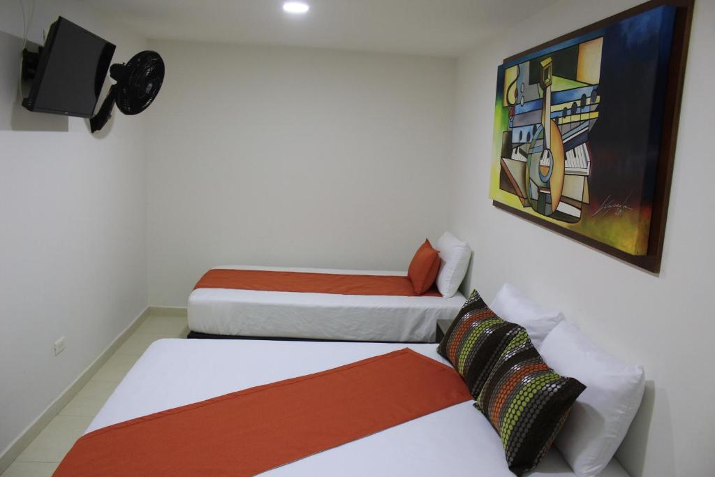 Postel nebo postele na pokoji v ubytování Hotel Pereira 421