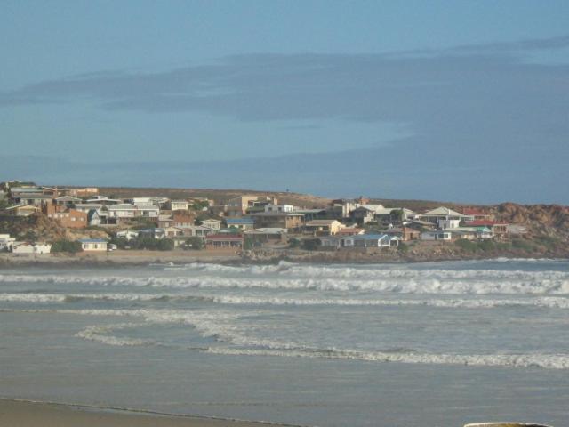 a group of houses on the shore of a beach at Voni's Cottage in Vredendal