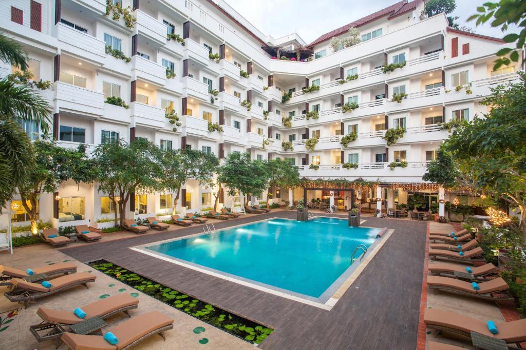 an image of the courtyard of a hotel with a swimming pool at Hill Fresco Hotel in Pattaya South