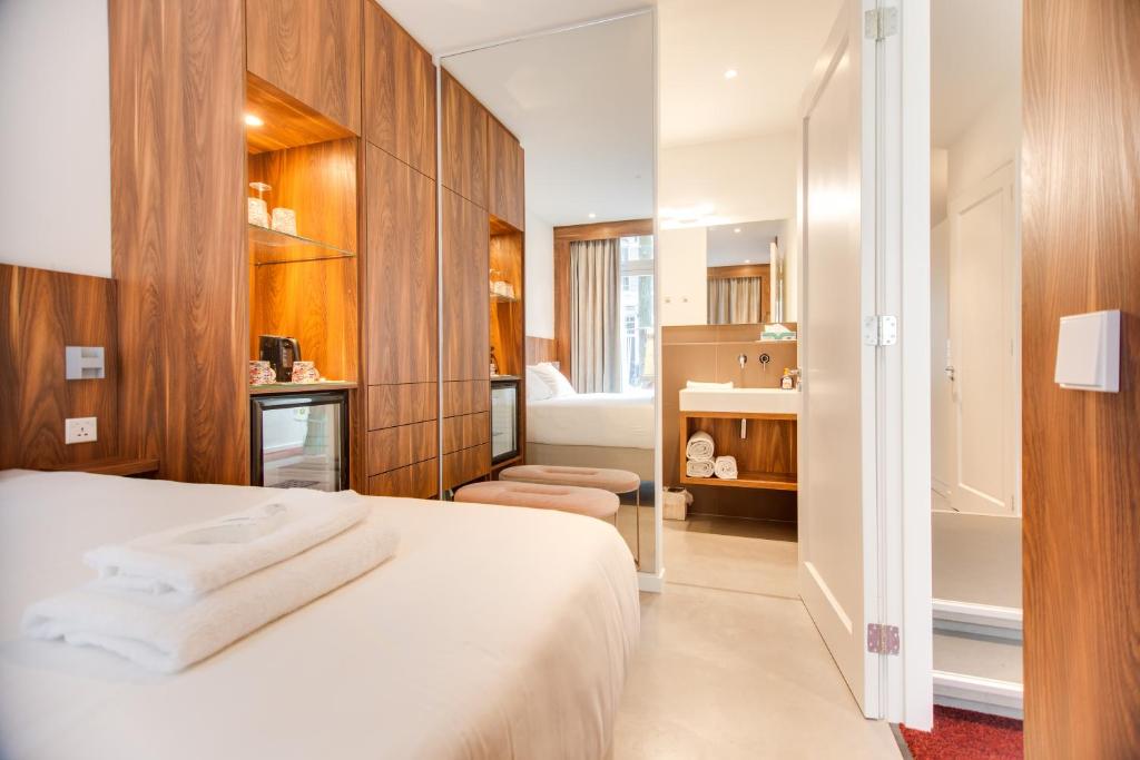 um quarto de hotel com uma cama e uma casa de banho em Het Kabinet em Amsterdã
