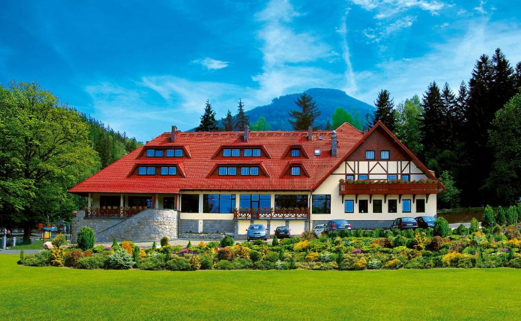 a large house with a red roof at Hotel Relaks Wellness & SPA in Karpacz