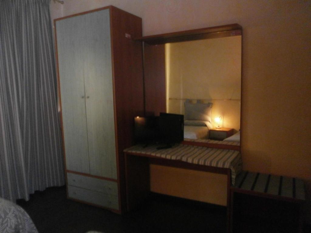 Postel nebo postele na pokoji v ubytování Albergo Vecchio Pavone