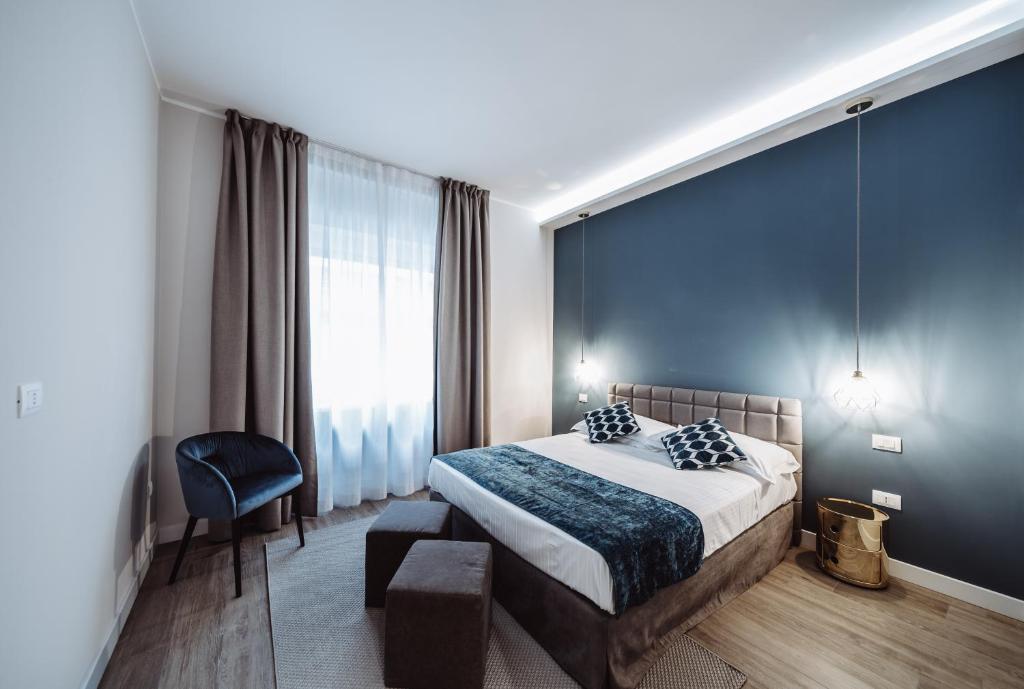 a bedroom with a bed and a blue wall at Estella luxury suites in Turin