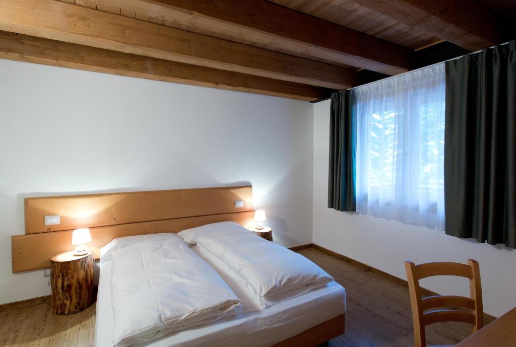 Postel nebo postele na pokoji v ubytování Residence Civetta