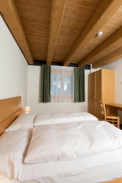 Postel nebo postele na pokoji v ubytování Residence Civetta