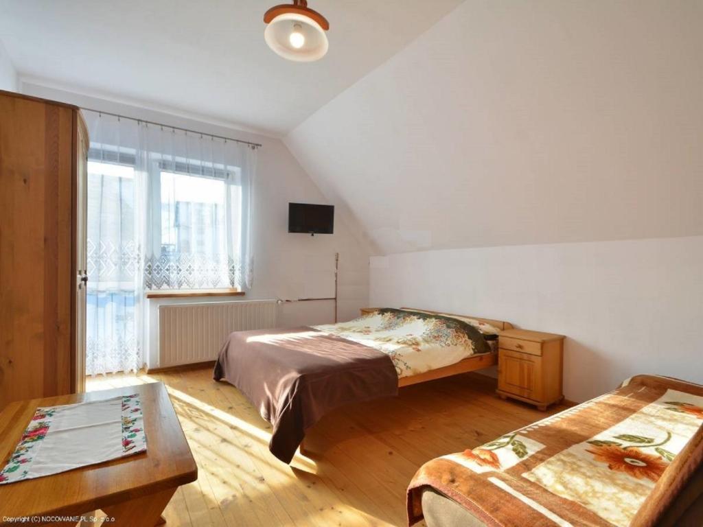 Postel nebo postele na pokoji v ubytování Winnica Spisz