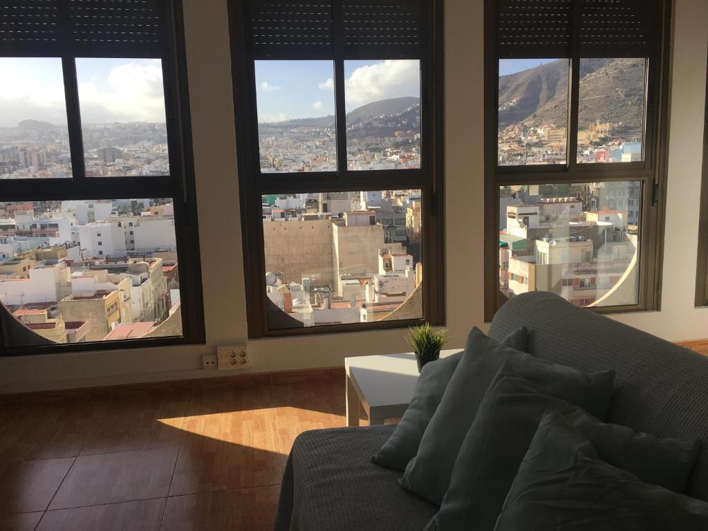 a living room with a couch and large windows at Vacacional balcon al mar centro Santa cruz in Santa Cruz de Tenerife