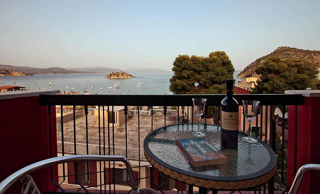 a bottle of wine sitting on a table on a balcony at Epidavria Hotel in Tolo