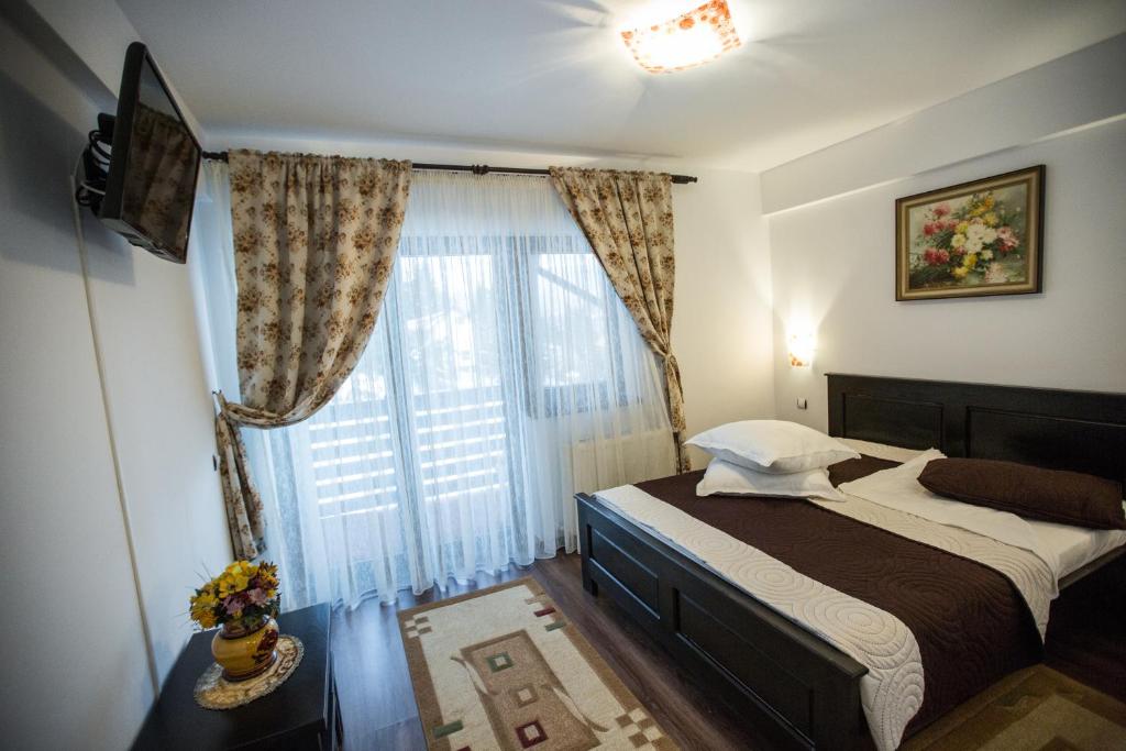 Postel nebo postele na pokoji v ubytování Poarta Calimanilor