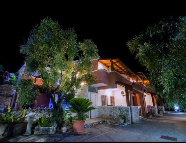 a house with lights on the side of it at night at Villa Calma in Vieste