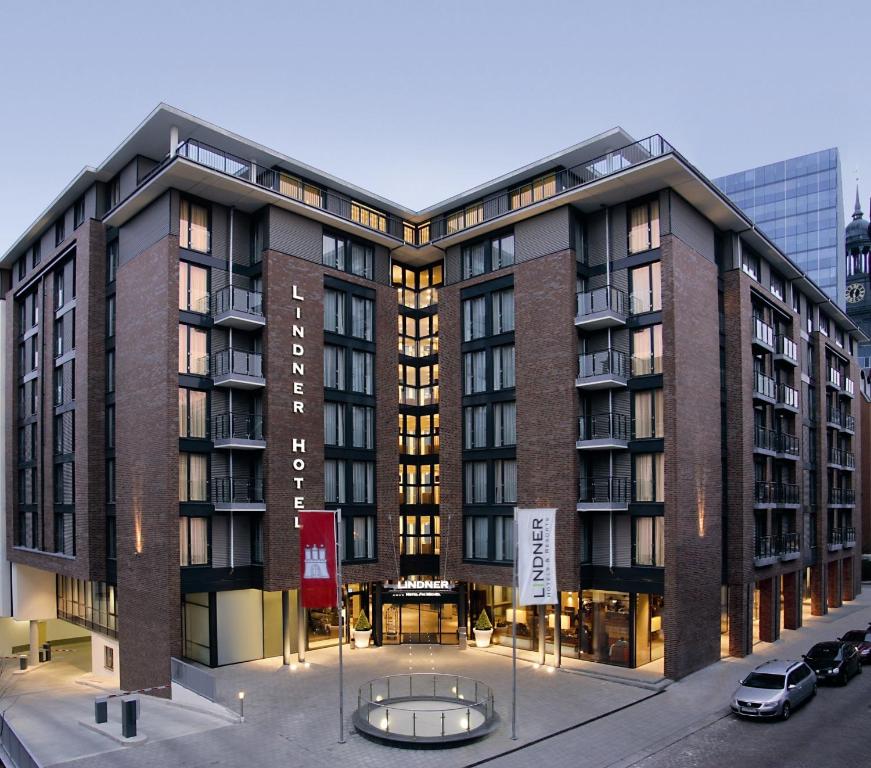 a large building with a parking lot in front of it at Lindner Hotel Am Michel in Hamburg