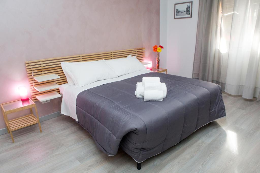 a bedroom with a large bed with two pillows on it at Foresteria Boccadasse in Genoa