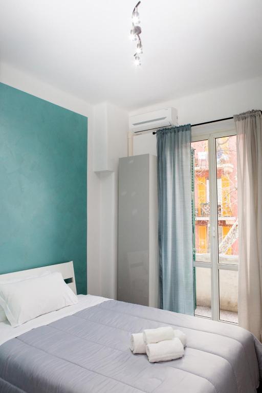 a bedroom with a bed with two towels on it at Foresteria Boccadasse in Genoa