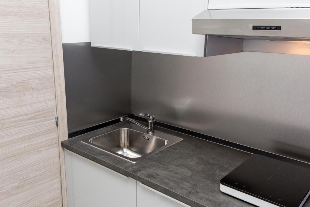 a stainless steel sink in a small kitchen at Foresteria Boccadasse in Genoa