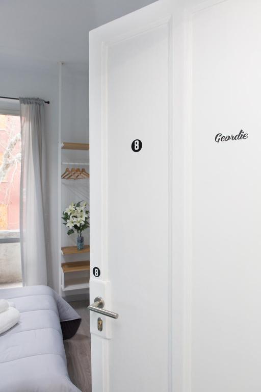 a door to a bedroom with a bed and a window at Foresteria Boccadasse in Genoa