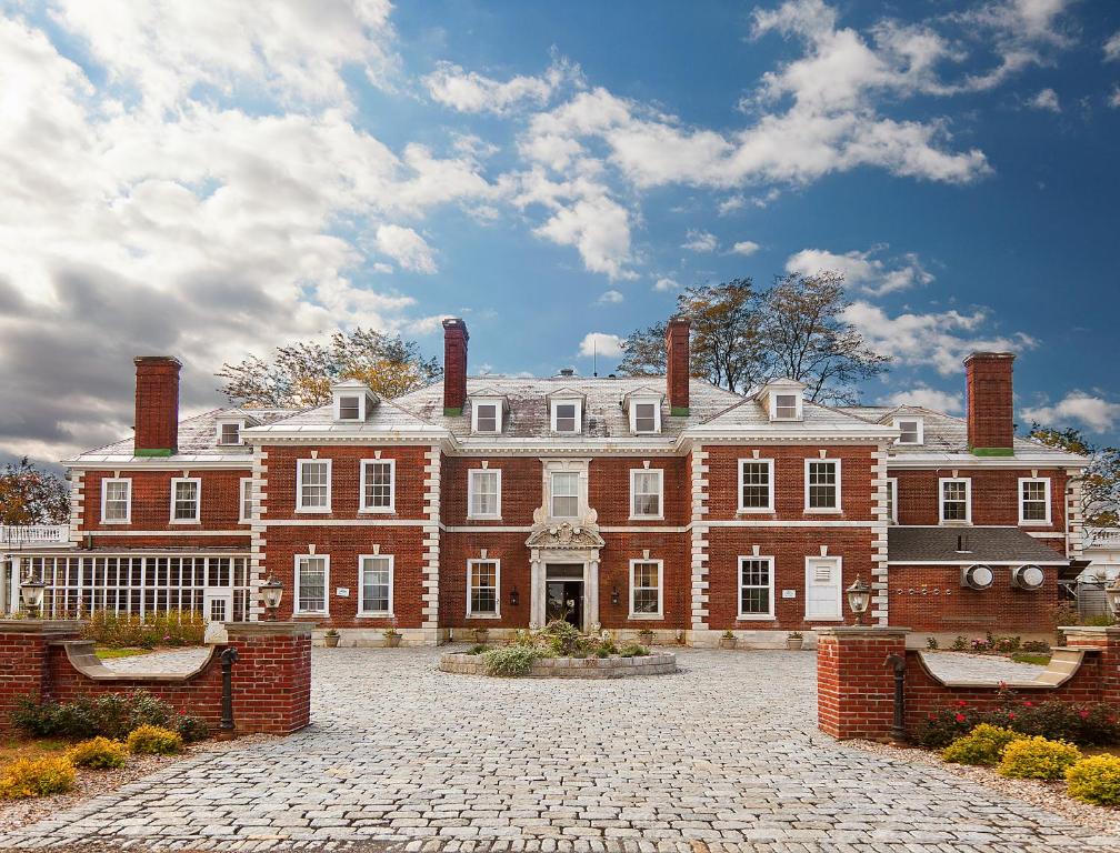a large red brick building with two chimneys at Eastover Estate and Eco Village in Lenox