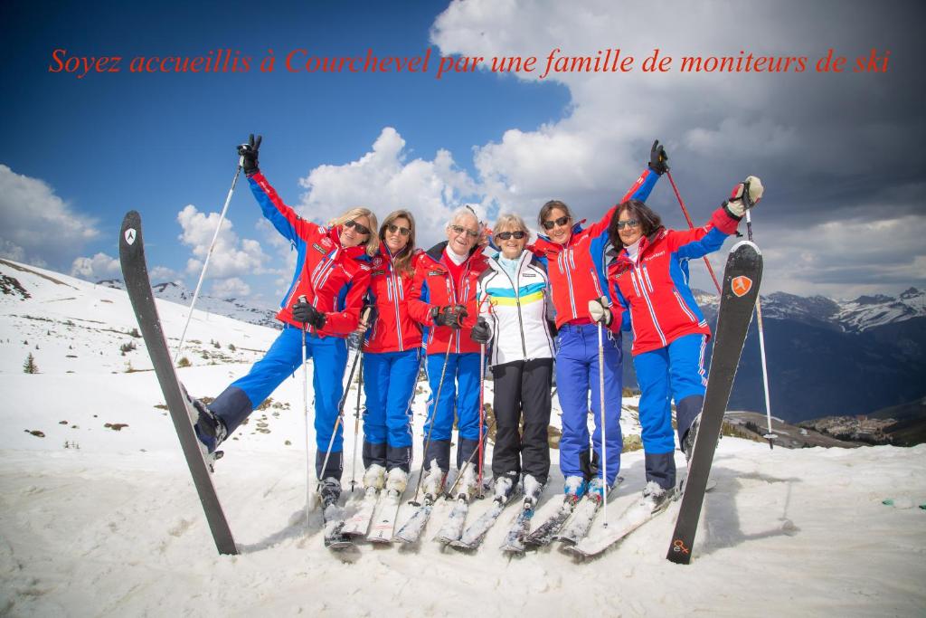 a group of people on skis posing for a picture at Chalet Lafarge in Courchevel