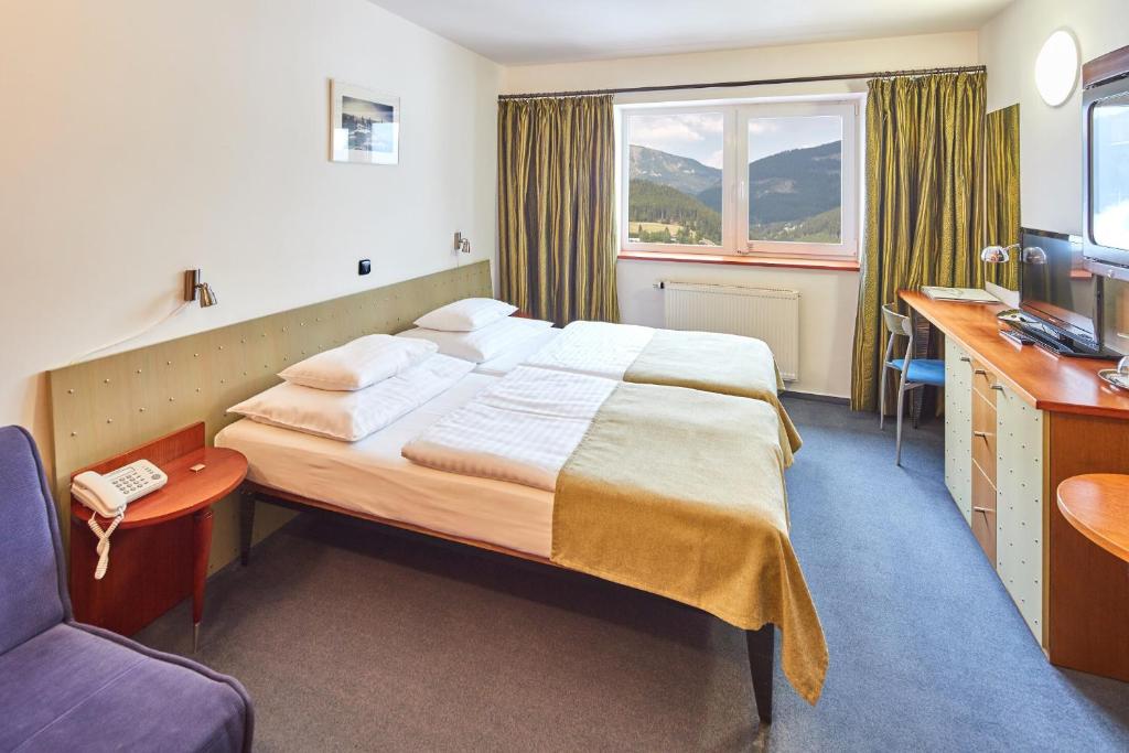 Postel nebo postele na pokoji v ubytování Hotel Horizont