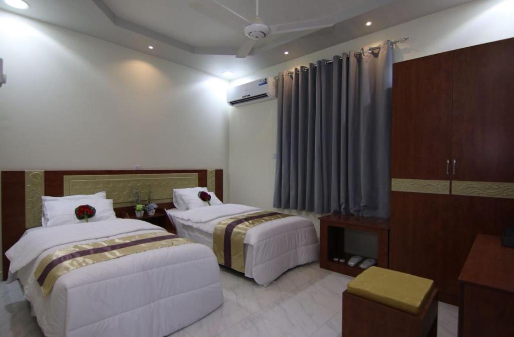 Postel nebo postele na pokoji v ubytování Bahla Jewel Hotel Apartments
