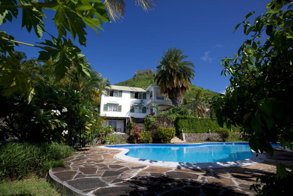 a house with a swimming pool in front of it at Tamarin Chambres d'Hotes in Tamarin