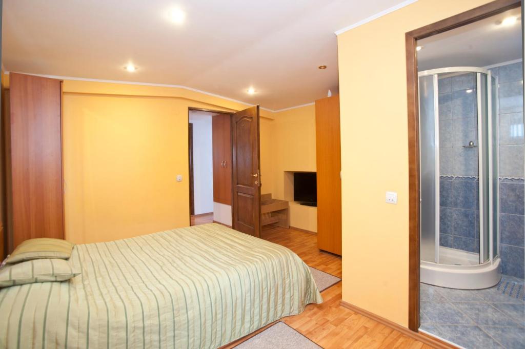 een slaapkamer met een bed en een glazen schuifdeur bij Casa Tudor in Sinaia