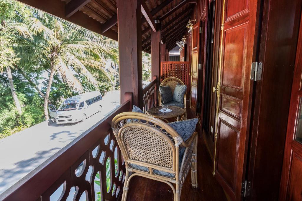 Deluxe Riverview Room Seating Area and Teak Desk