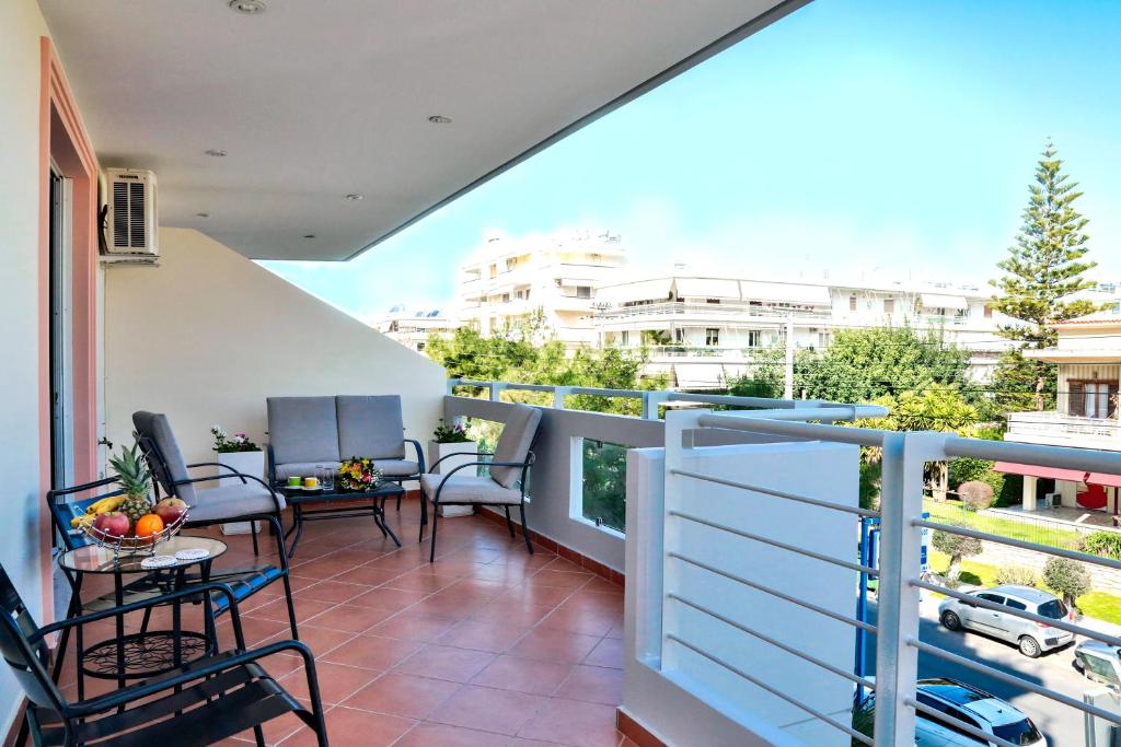 a balcony with chairs and tables on a balcony at Boutique52 Luxury Apartments in Athens