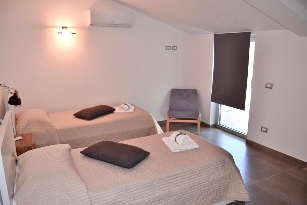 Postel nebo postele na pokoji v ubytování Corte Sveva B&B Affittacamere