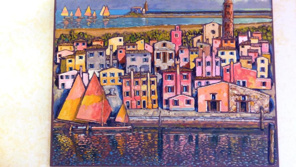 a painting of a city with a sail boat at La Casa di Enrico in Caorle