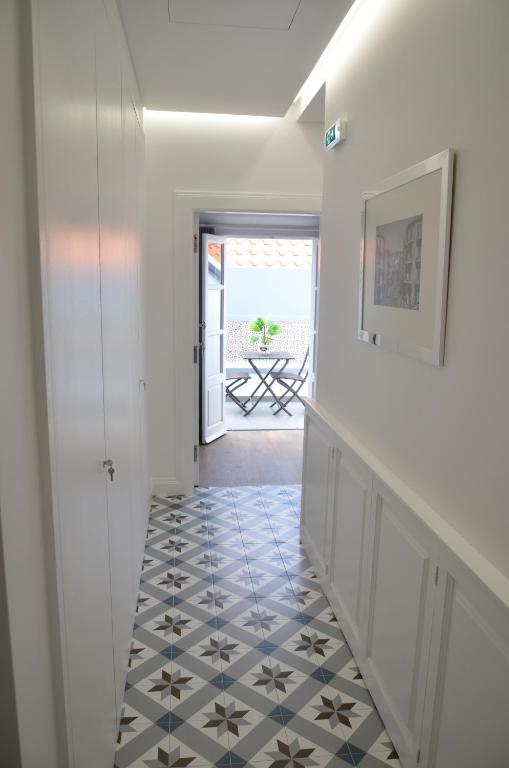 a hallway with a blue and white tile floor at Edificio Charles 303 in Funchal