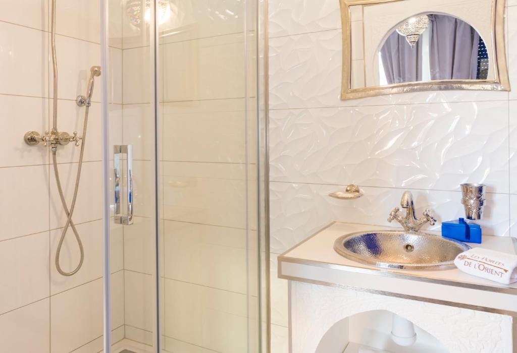 a bathroom with a shower and a sink at Riad SPA &quot;Les Portes de l&#39;Orient&quot; TOURS in Tours