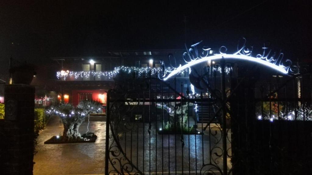 a gate with lights on it at night at Hotel Il Dito e la Luna in Ripa Teatina