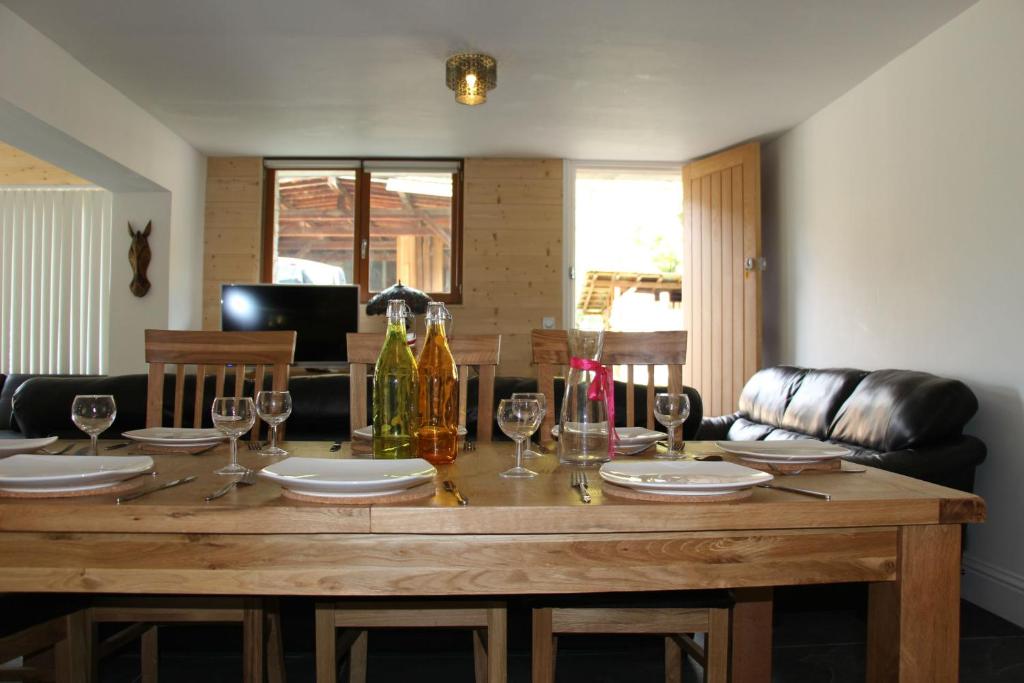 una mesa de madera con copas y botellas de vino. en Chalet Marmotte 3 en Morzine