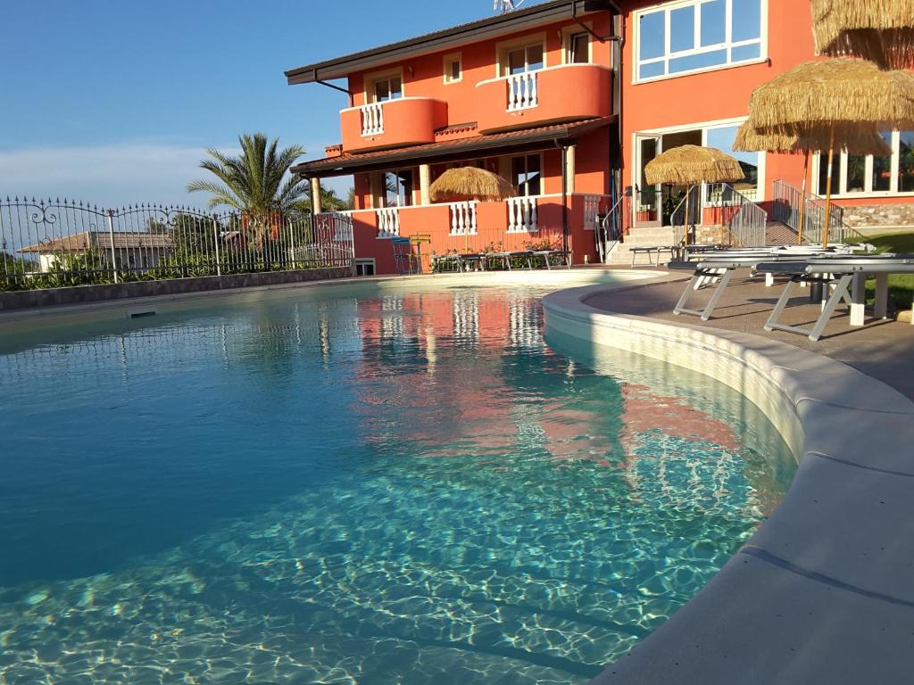a swimming pool in front of a building at Borgo di Santa Barbara in Santa Domenica